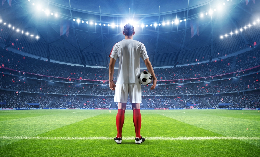 Football,Player,With,Ball,In,The,Stadium,,3d,Rendering